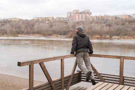 Man leaning his hands on railing and jumping.の写真素材