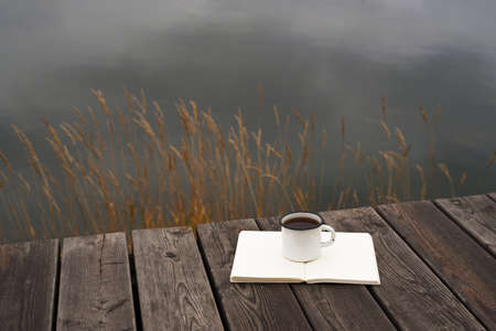 Coffee, river and blank pagesの写真素材