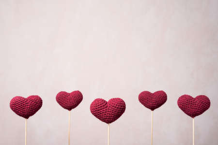 Five crocheted hearts on wooden sticksの写真素材