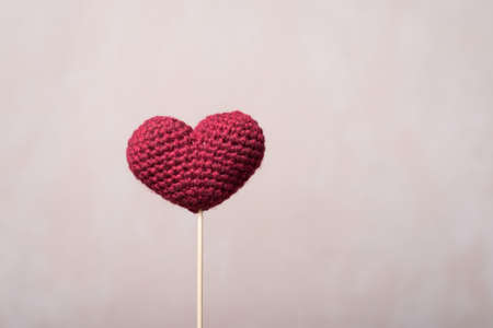 Crocheted heart on a wooden stickの写真素材