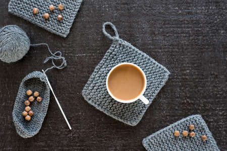 Coffee, wooden beads and crocheting on blackの写真素材