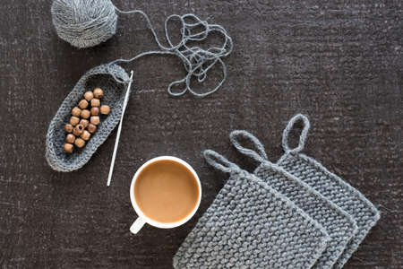 Coffee, wooden beads and crocheting on blackの写真素材