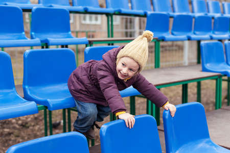 Little girl playing on a standの写真素材