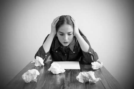 Woman crying over a blank sheetの写真素材