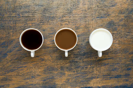 Three cups with coffee and milk on grunge backgroundの写真素材