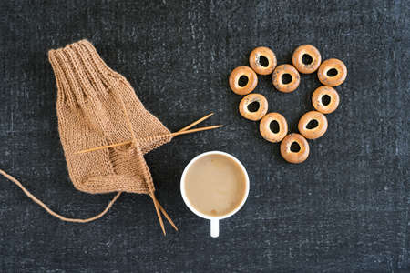 Knitting with coffee and ring-shaped cracknelsの写真素材