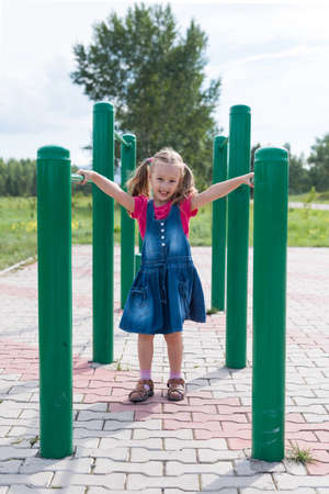 Little girl on a sport trainer outdoors in the parkの写真素材