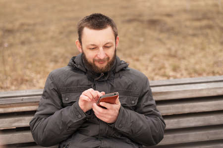 Young man with a smartphone outdoors