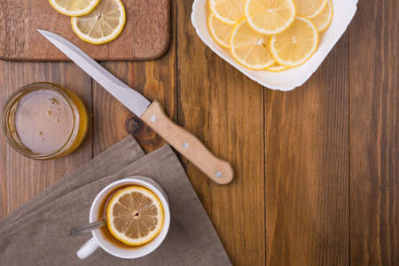 Composition with lemon tea on a wooden table shot overhead.の写真素材