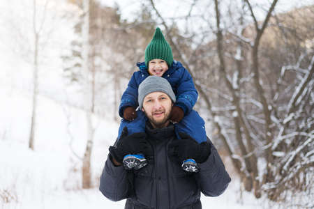 Father and child in a winter forest
