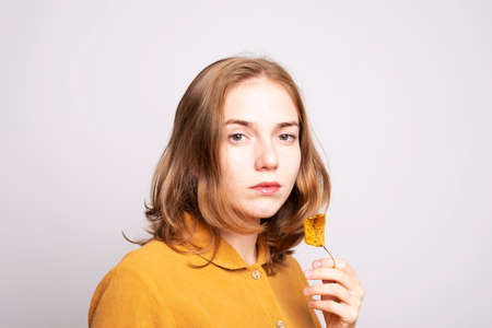 Portrait of a beautiful woman in a yellow dressの写真素材