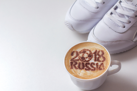 A cup of coffee with foam and powder in the shape of a soccer ball.(series)の写真素材