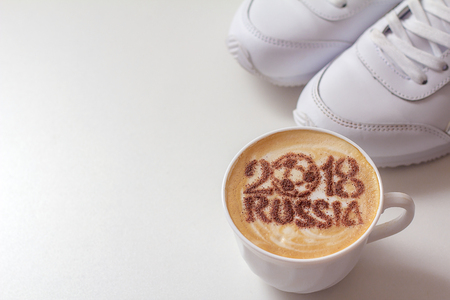 A cup of coffee with foam and powder in the shape of a soccer ball.(series)の写真素材