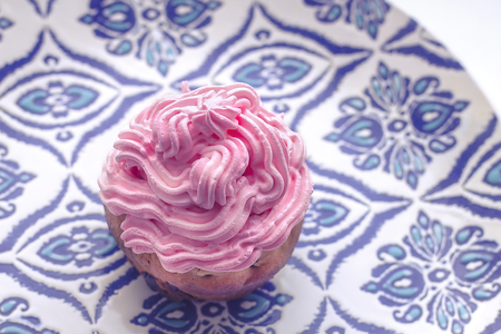 Pumpkin cupcake on blue background with mini pumpkinの写真素材