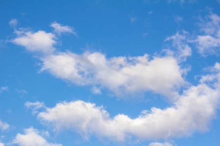 Blue sky background with cloudsの写真素材