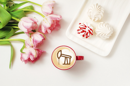 a cup of cappuccino coffee with a drawing of an oil producing tower from cinnamon on milk foamの写真素材