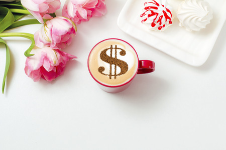 cup of coffee cappuccino with a picture of a dollar sign from cinnamon on milk foamの写真素材