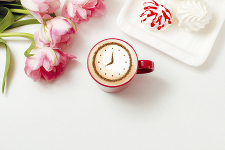 a cup of coffee cappuccino with a clock pattern from cinnamon on milk foamの写真素材