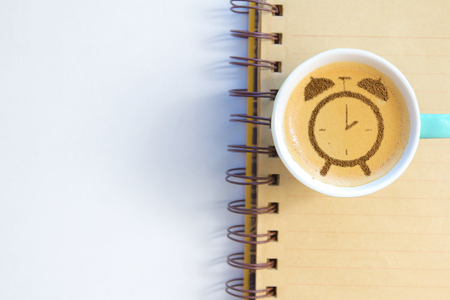 cup of cappuccino with pattern of cinnamon clock on milk foamの写真素材