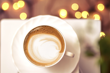 Top view of hot coffee cappuccino latte art in a ceramic glassの写真素材