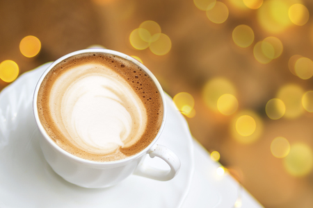Top view of hot coffee cappuccino latte art in a ceramic glassの写真素材