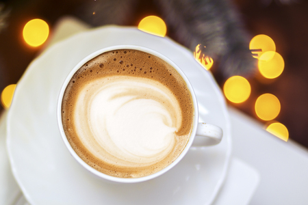 Top view of hot coffee cappuccino latte art in a ceramic glassの写真素材