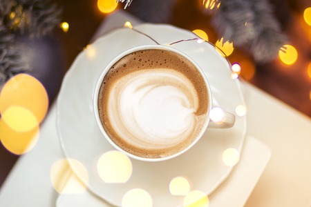 Top view of hot coffee cappuccino latte art in a ceramic glassの写真素材