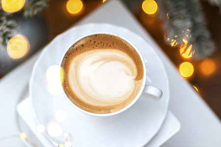 Top view of hot coffee cappuccino latte art in a ceramic glassの写真素材