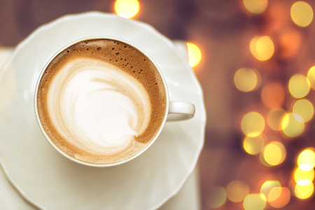 Top view of hot coffee cappuccino latte art in a ceramic glassの写真素材