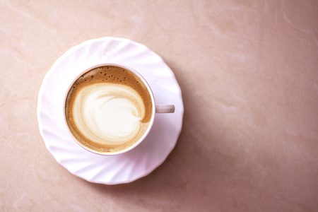 Top view of hot coffee cappuccino latte art in a ceramic glassの写真素材