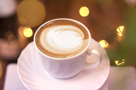Top view of hot coffee cappuccino latte art in a ceramic glassの写真素材
