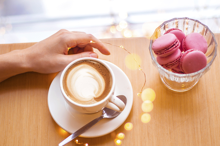 Top view of hot coffee cappuccino latte art in a ceramic glassの写真素材