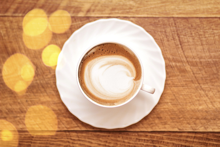 Top view of hot coffee cappuccino latte art in a ceramic glassの写真素材