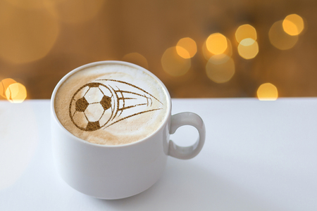 Coffee cappuccino in a cup for breakfast for a football fanの写真素材