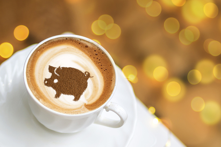 coffee cappuccino in a cup with a pattern of the symbol of 2019 pig on milk foam. The pig is a symbol of the year 2019 in the Chinese calendar.の写真素材