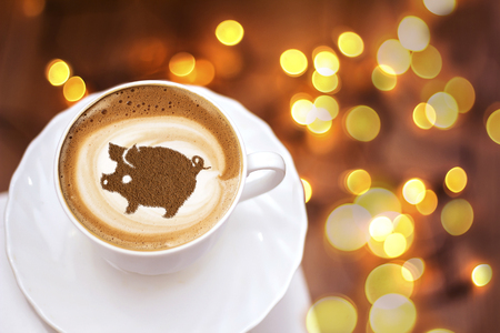 coffee cappuccino in a cup with a pattern of the symbol of 2019 pig on milk foam. The pig is a symbol of the year 2019 in the Chinese calendar.の写真素材