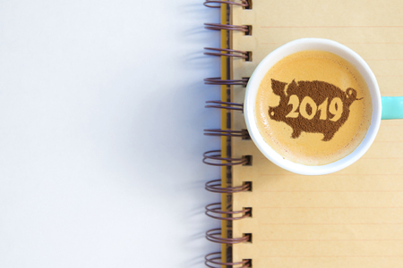 coffee cappuccino in a cup with a pattern of the symbol of 2019 pig on milk foam. The pig is a symbol of the year 2019 in the Chinese calendar.の写真素材