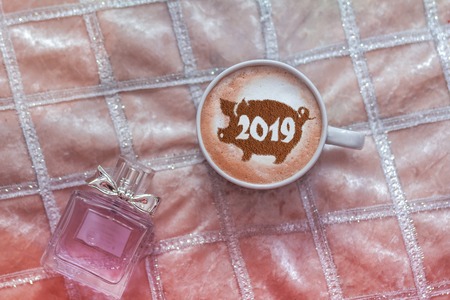 coffee cappuccino in a cup with a pattern of the symbol of 2019 pig on milk foam. The pig is a symbol of the year 2019 in the Chinese calendar.の写真素材