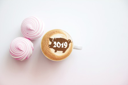coffee cappuccino in a cup with a pattern of the symbol of 2019 pig on milk foam. The pig is a symbol of the year 2019 in the Chinese calendar.の写真素材
