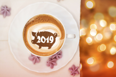 coffee cappuccino in a cup with a pattern of the symbol of 2019 pig on milk foam. The pig is a symbol of the year 2019 in the Chinese calendar.の写真素材