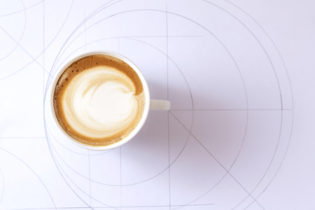 a cup of cappuccino coffee in a ceramic cup on the tableの写真素材