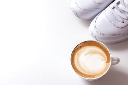 a cup of cappuccino coffee in a ceramic cup on the tableの写真素材