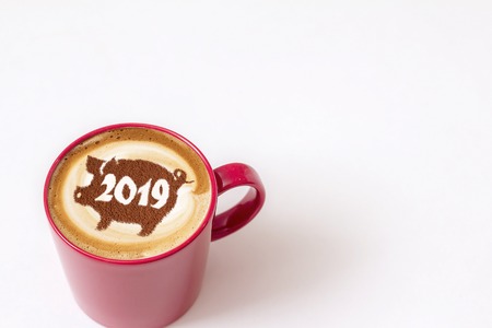 coffee cappuccino in a cup with a pattern of the symbol of 2019 pig on milk foam. The pig is a symbol of the year 2019 in the Chinese calendar.の写真素材