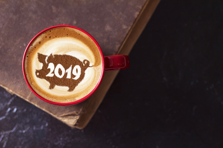 coffee cappuccino in a cup with a pattern of the symbol of 2019 pig on milk foam. The pig is a symbol of the year 2019 in the Chinese calendar.の写真素材
