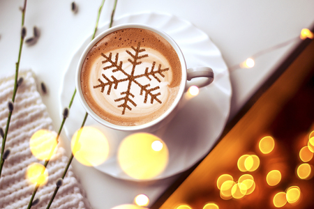 Cappuccino with a pattern of snowflakes from cinnamon on milk foam during Christmas holidays coffee for christmasの写真素材
