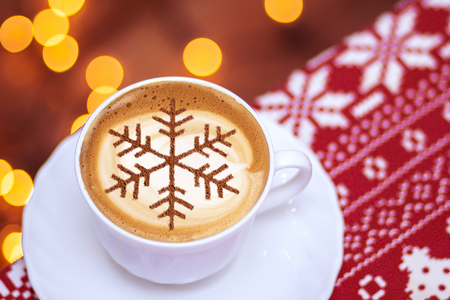 Cappuccino with a pattern of snowflakes from cinnamon on milk foam during Christmas holidays coffee for christmasの写真素材