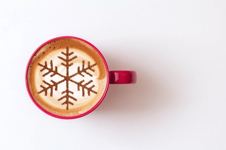 Cappuccino with a pattern of snowflakes from cinnamon on milk foam during Christmas holidays / coffee for christmasの写真素材