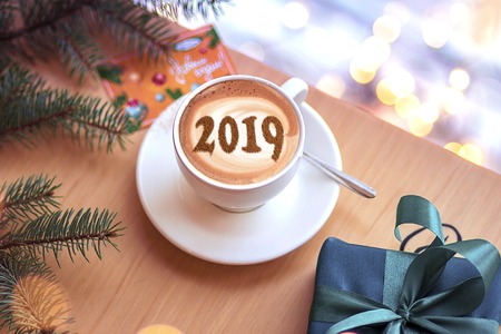 a cup of cappuccino coffee with a symbol of the NEW YEAR 2019 on milk foamの写真素材