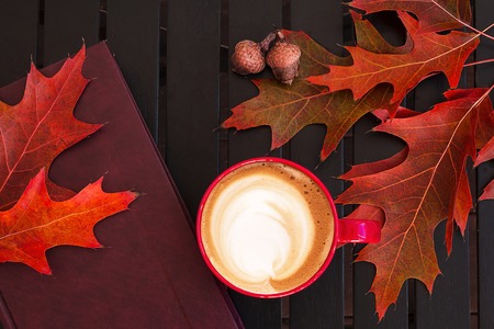 Autumn composition. Cup of coffee, dried leaves, light background. Autumn elegant concept. Flat lay, top view, copy spaceの写真素材