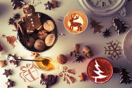 Beautiful Christmas background cookies and cap of coffee on dark backgroundの写真素材
